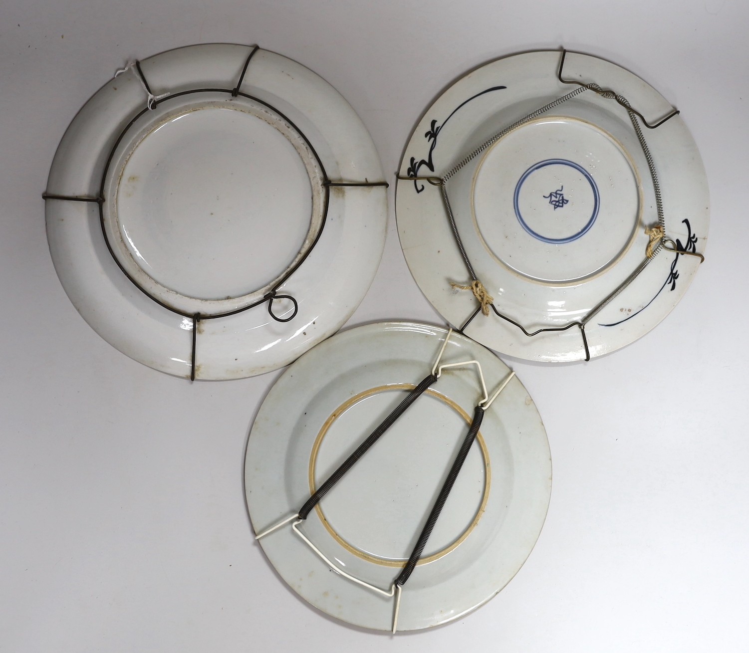 A 19th century Chinese enamelled porcelain dish, 25.4cm and two 18th century Chinese exports porcelain plates (3)